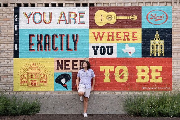 San antonio themed mural is the backdrop to frame this high school senior boy's portrait