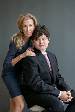 Mother holding her son's shoulder in  formal portraits