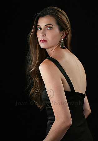 Glamour session  in Black silk dress looking over her shoulder